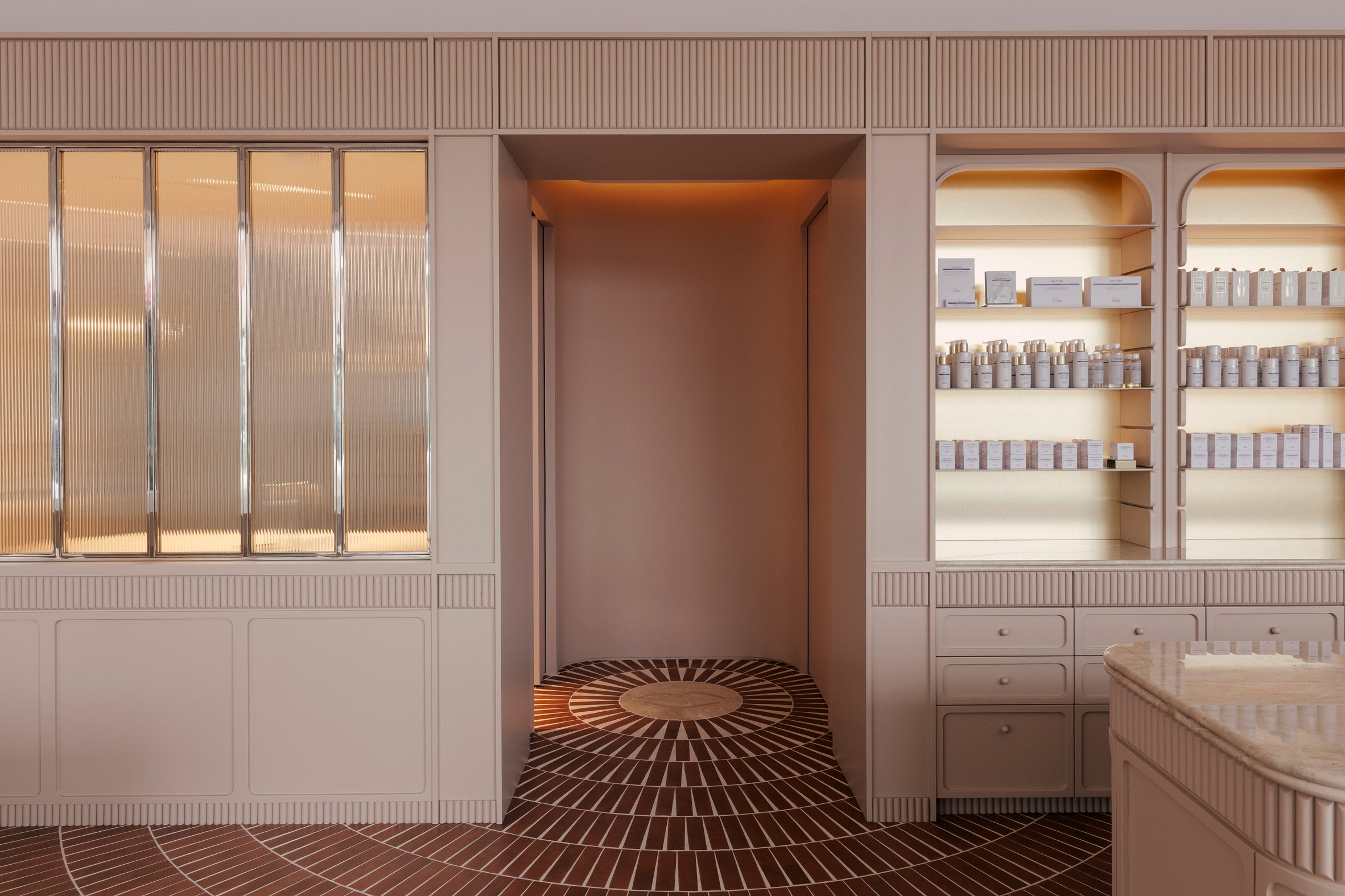 Concentric terracotta-hued floor tiles converge in a doorway