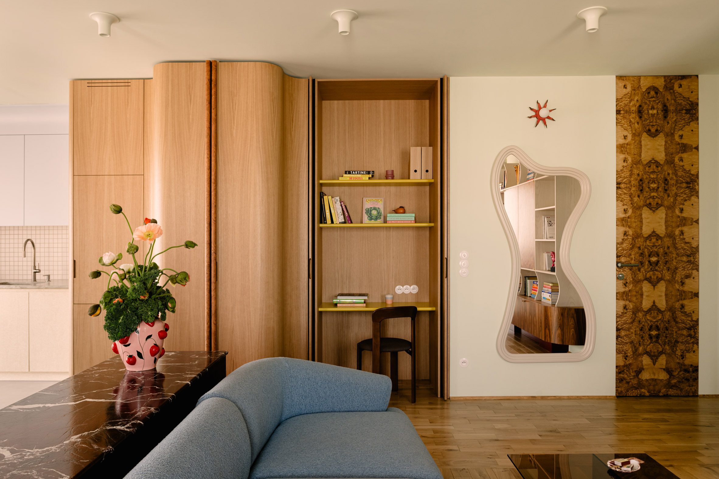 Organic-shaped mirror positioned by Mistovia