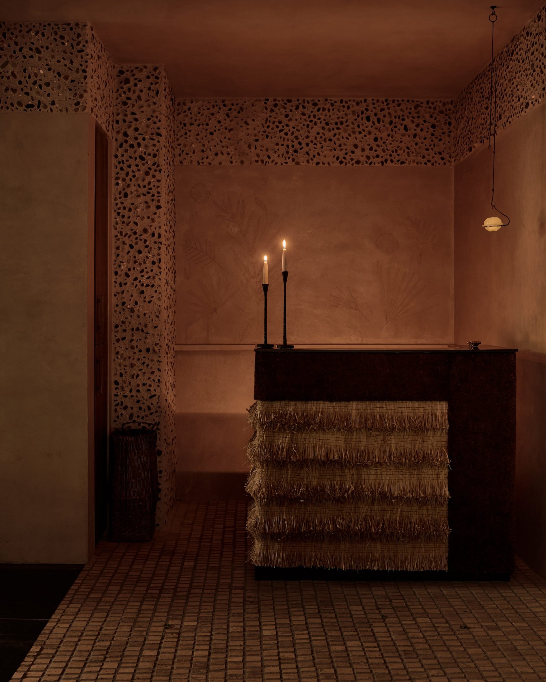 Restaurant host stand wrapped in layers of woven fringe 