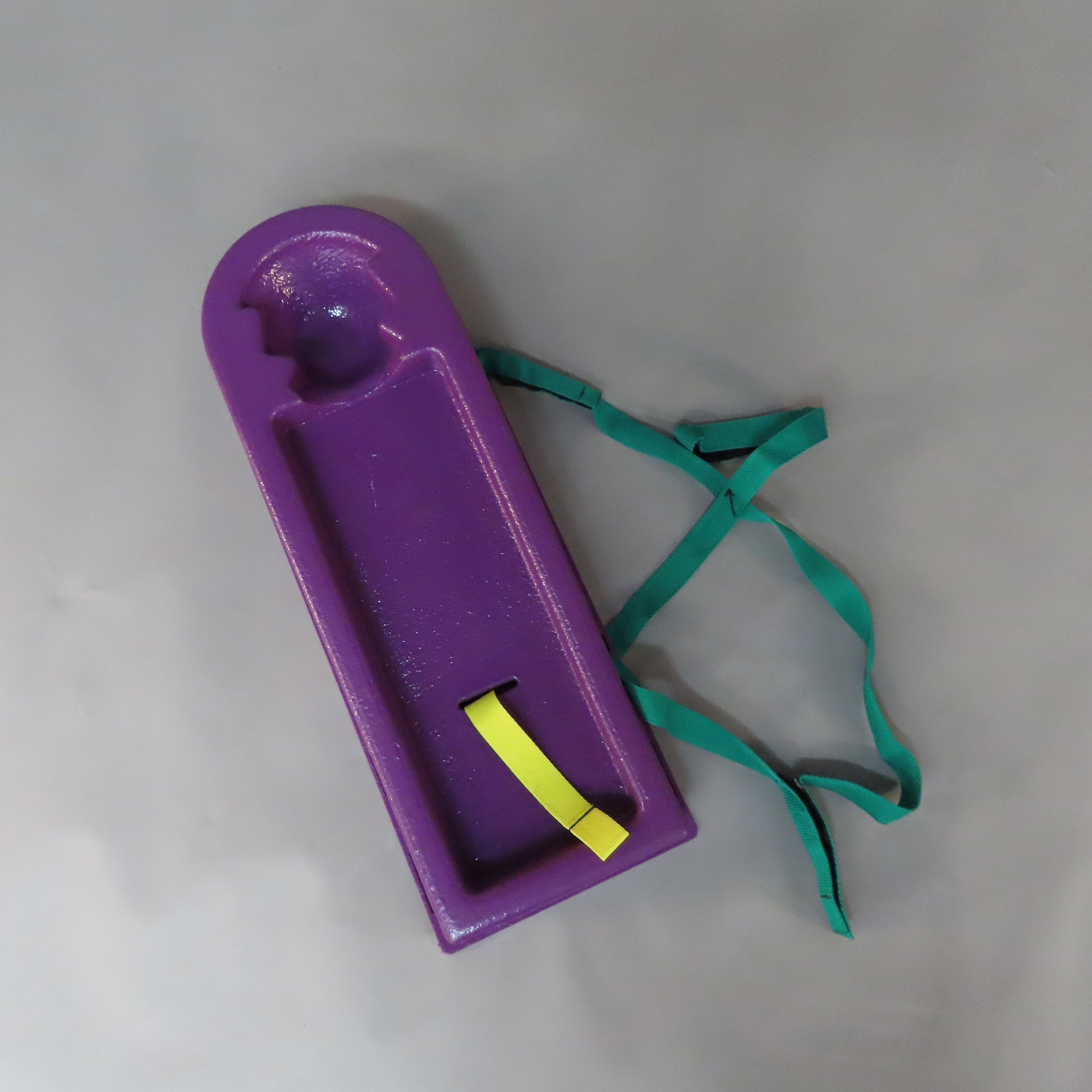 Purple medical device with green and yellow string-like material
