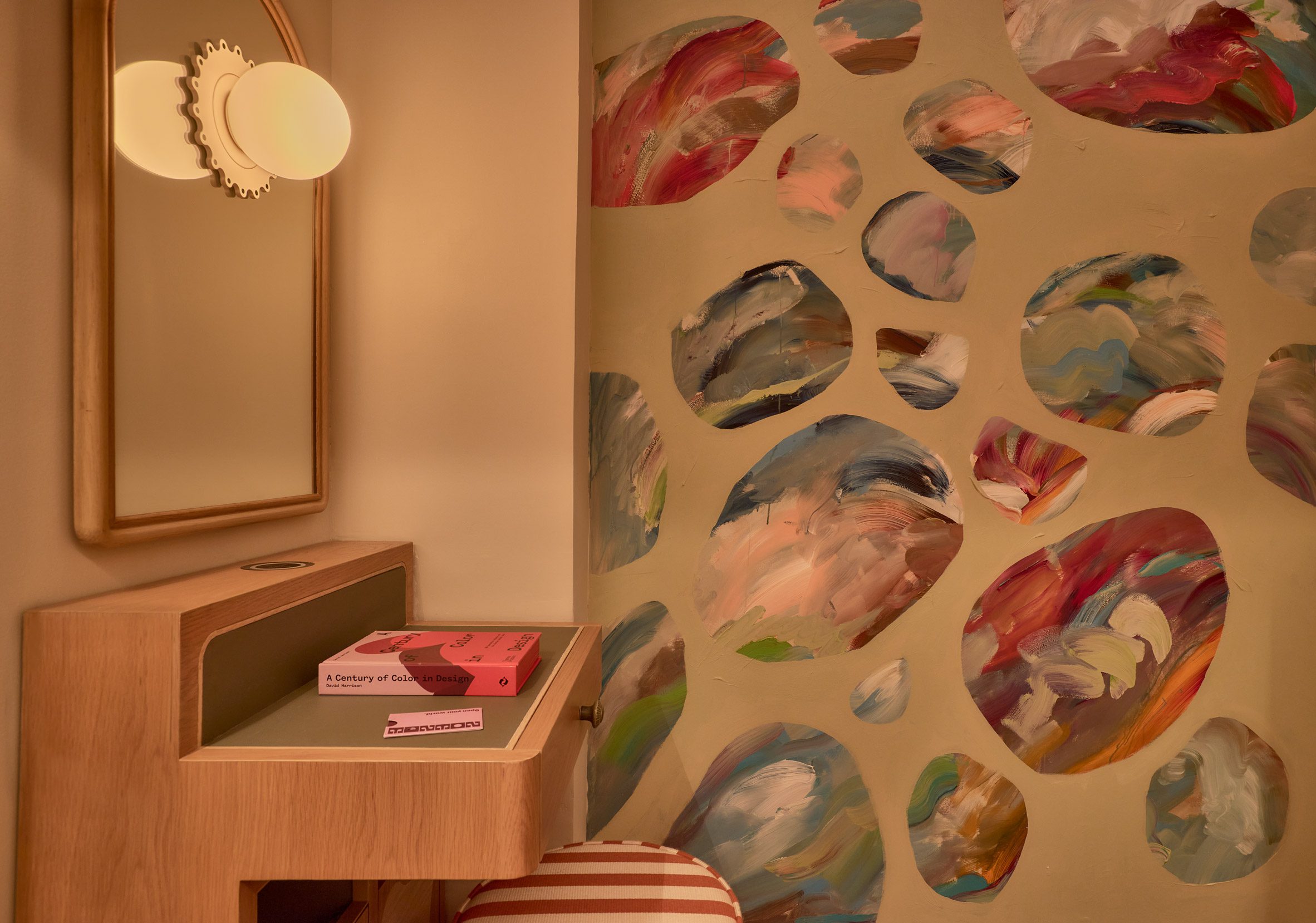A small table beside a colourful wall mural