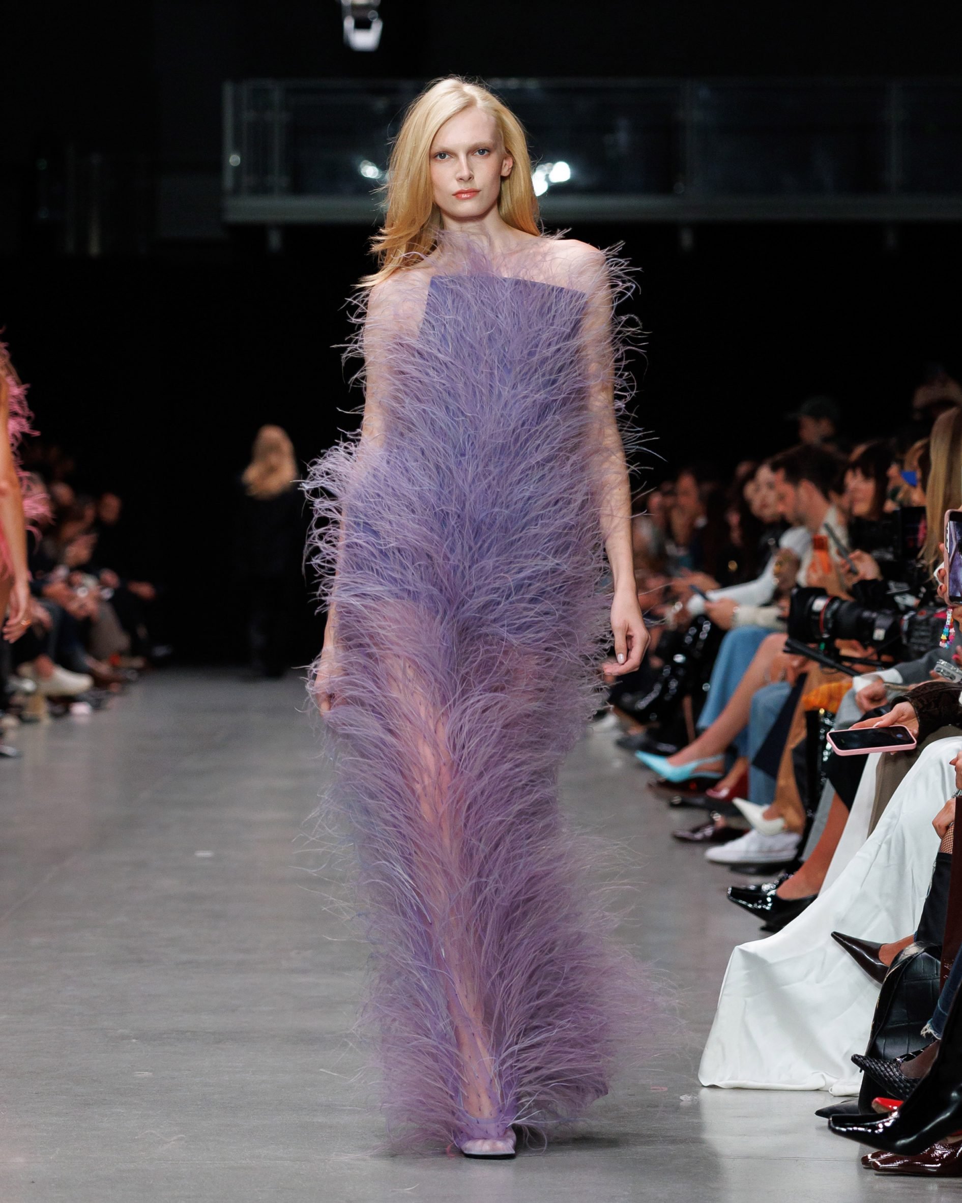 Plant-based Fevvers feathers on a long purple gown in the Stella McCartney Spring/Summer26 show at Paris Fashion Week